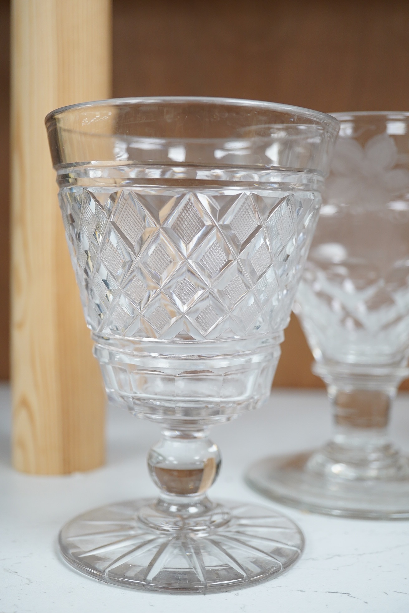 A George III tear drop cordial glass, a pair of hobnail cut bucket bowl rummers and a vineous engraved glass, tear drop glass 18cm high (5). Condition - good